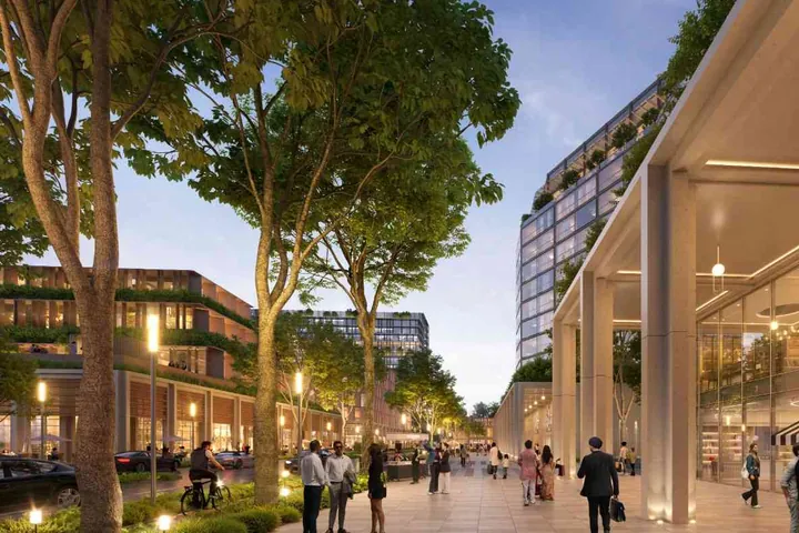 A tree-lined high street with glass shopfronts under a colonnade